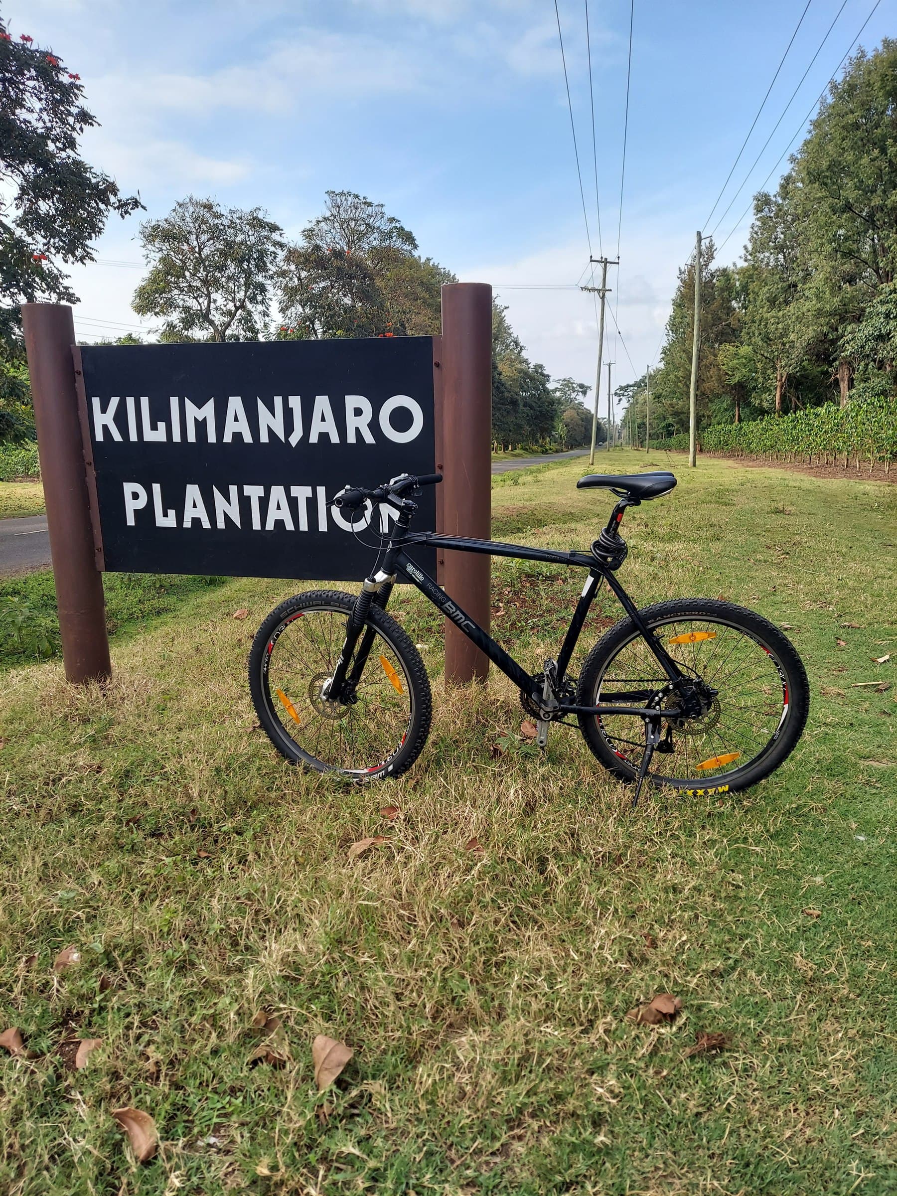 Mountain bike beside the Kilimanjaro Plantation sign in Tanzania